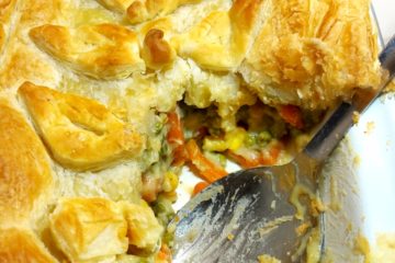 Vegan Vegetable Pie topped with puff pastry with a portion removed