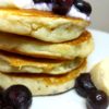 Vegan Blueberry Pancakes topped with vegan yogurt and bananas