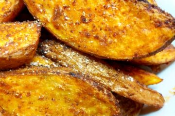 Spicy Potato Wedges piled up on a white plate